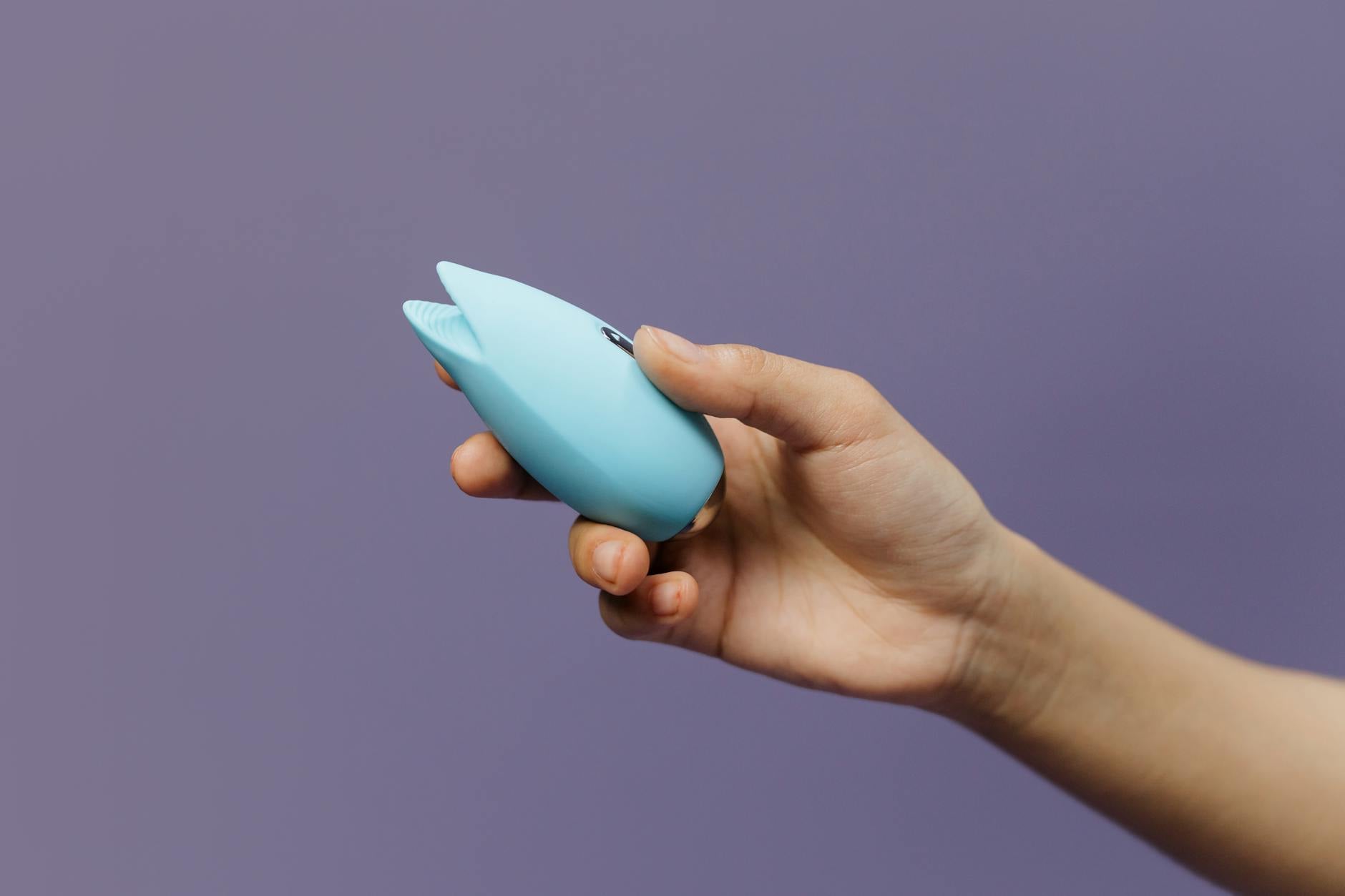 Woman holding lemon clitoral vibrators with confidence and ease